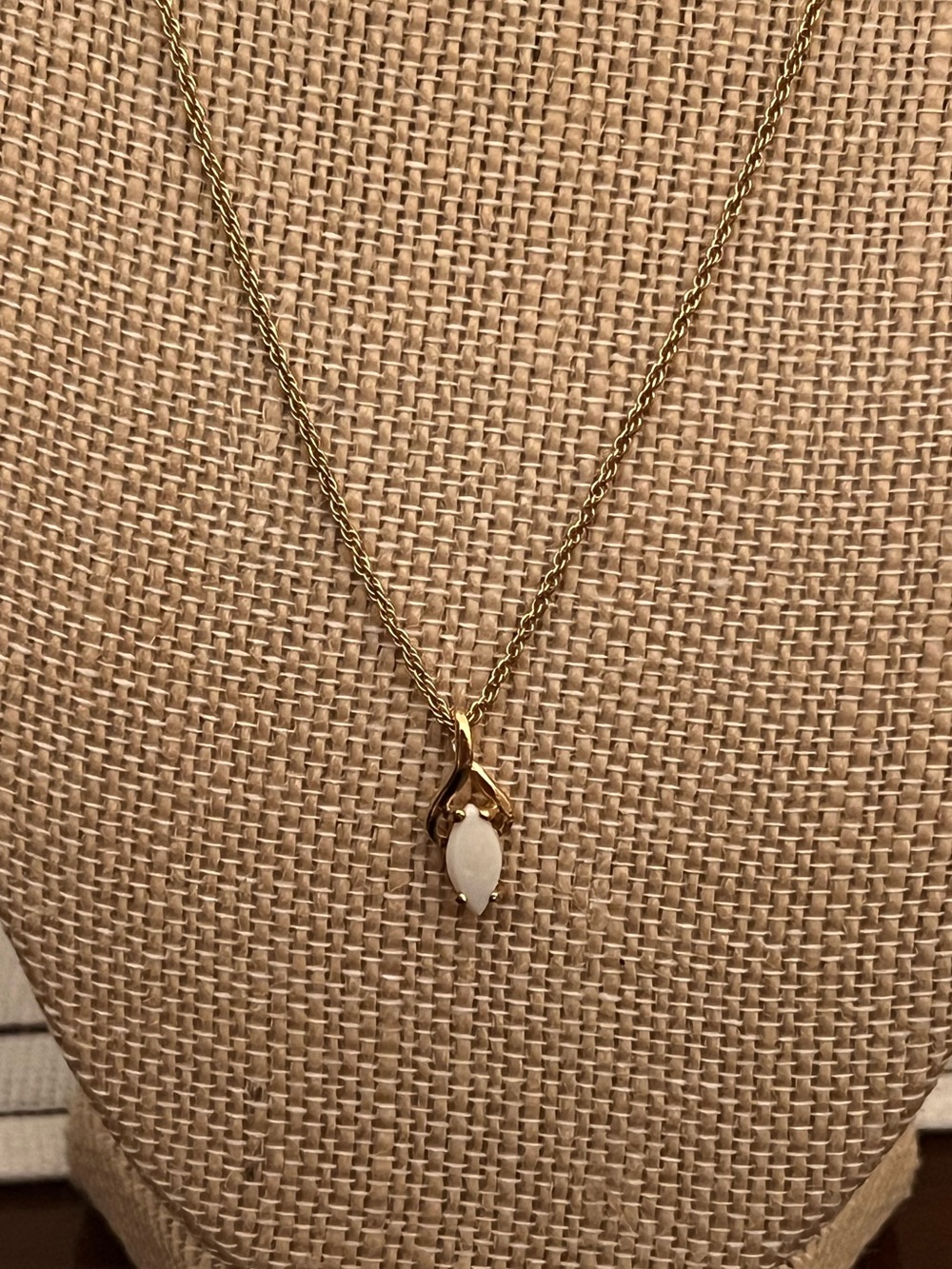 Gold tone 18” necklace with white marquis shaped stone pendant